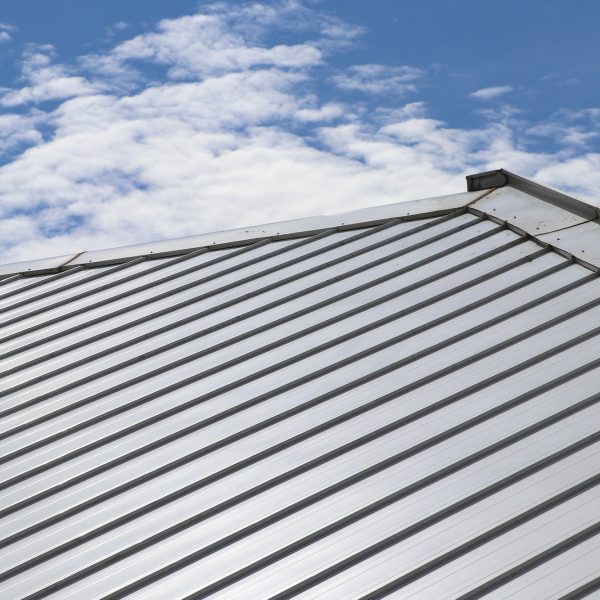 Close up metal roof with sky.